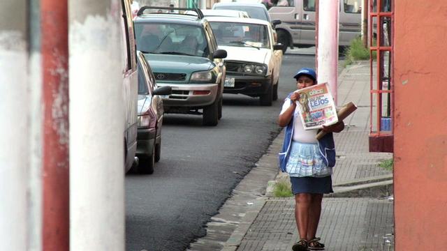 Maria sells newspapers in El Salvador