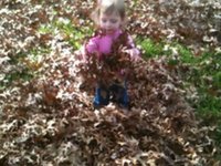 Clare and Reed playing in the leaves