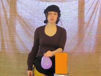 Absurdity, for orange box, purple balloon and purple anti-stress ball